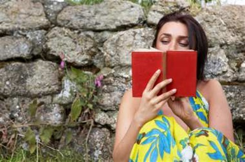 woman-reading-book-by-stone-wall-1995603.jpg